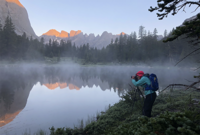 landscape photographer in a foggy mountain scene